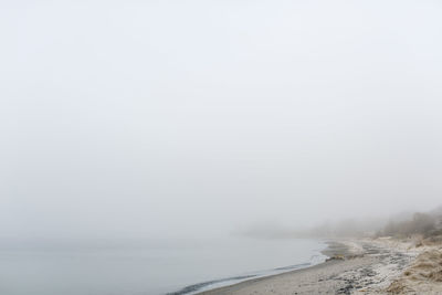 Scenic view of beach in foggy weather