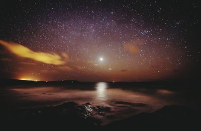 Scenic view of landscape against sky at night