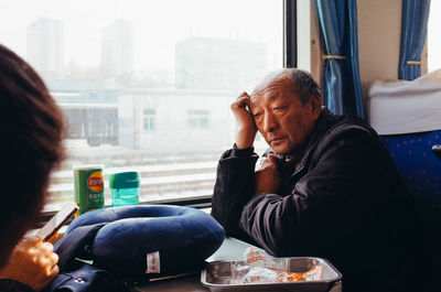 Man and woman sitting in bus