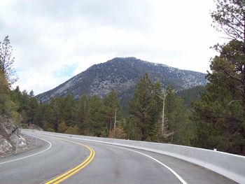 Road by mountain against sky