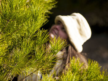 Close-up of woman by branch