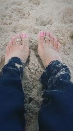 Low section of woman standing on beach