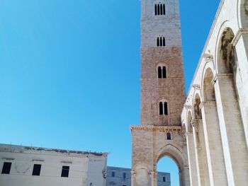 Low angle view of historical building against clear blue sky