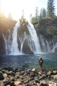 Scenic view of waterfall against sky