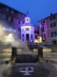 View of fountain in city at night