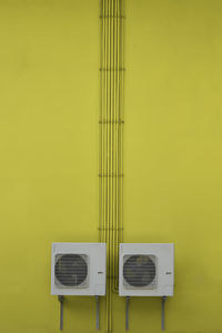 Close-up of yellow telephone on table