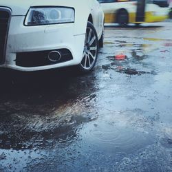 Close-up of wet car on street