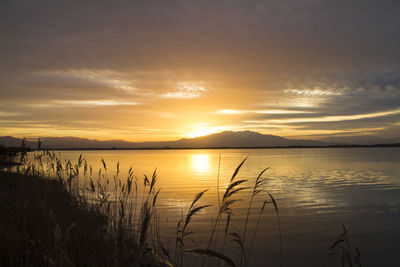 Scenic view of lake against sky during sunset