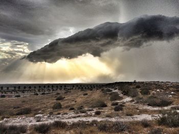 Scenic view of landscape against cloudy sky