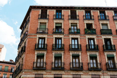 Low angle view of building against cloudy sky