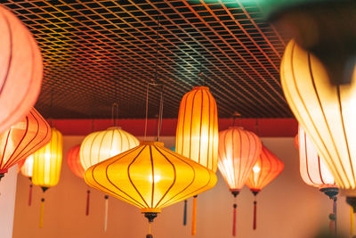 Low angle view of illuminated lanterns hanging on ceiling