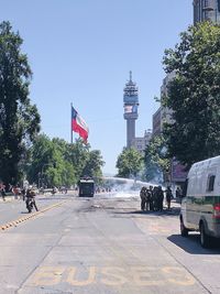 Flag in city against sky