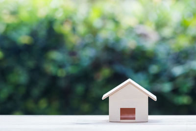 Close-up of birdhouse on house against building