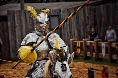 Knight in armor riding horse