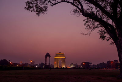 Illuminated triumphal arch against sky at night