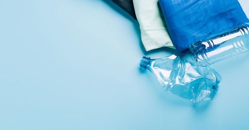 High angle view of blue bottle on white table