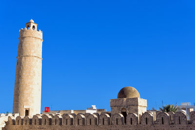 Low angle view of historical building against blue sky