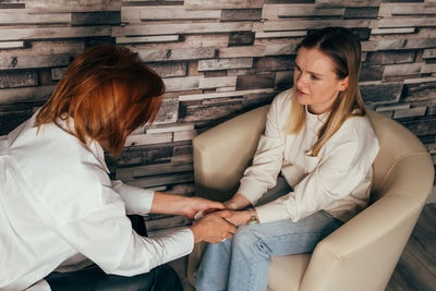 Depressed woman talking to psychotherapist at office.