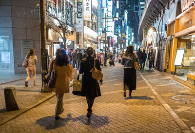 People walking on sidewalk in city