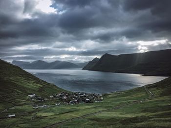 Scenic view of sea and mountains against sky