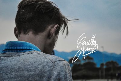 Rear view portrait of man against sky