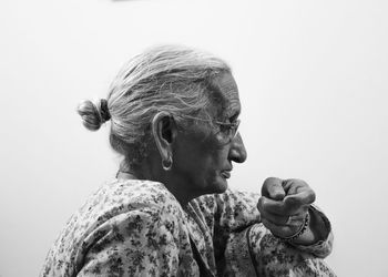 Portrait of woman against white background