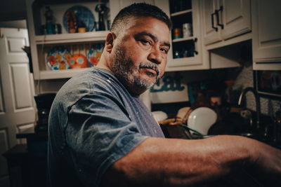 Portrait of man cooking in the kitchen at home 