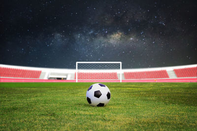 Close-up of soccer ball on field at night