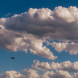 Helicopter in the clouds, flying over hudson river near manhattan.