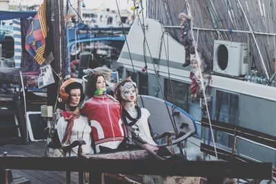 People sitting on harbor in city