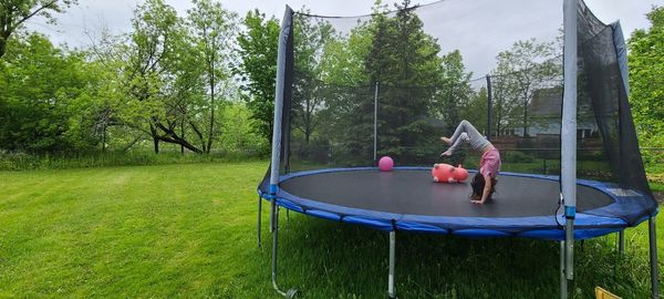 Girl playing trampoline upside down