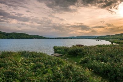 Scenic view of lake against sky during sunset