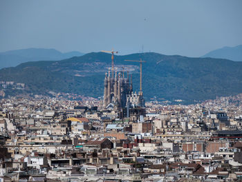 High angle view of barcelonas townscape against sky with sagrada familia.