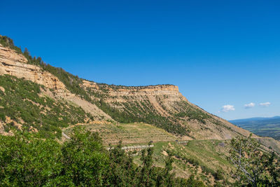 Scenic view of mountains against clear blue sky