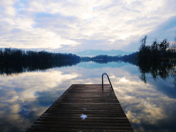 Pier over lake against sky