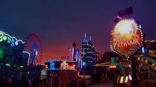 Illuminated ferris wheel at night