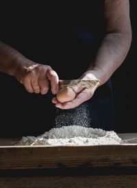 Midsection of man preparing food on table