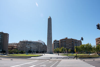 Buildings in city against clear sky