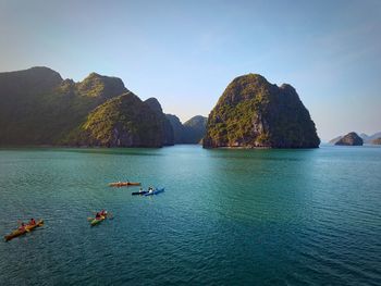 Scenic view of sea and rocks against clear sky