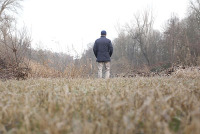 Rear view of man standing on field