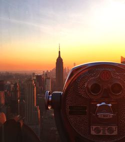 Coin-operated binoculars at observation point during sunset