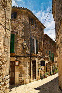 Street amidst buildings in town against sky