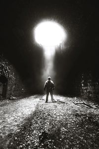 Man walking in illuminated tunnel