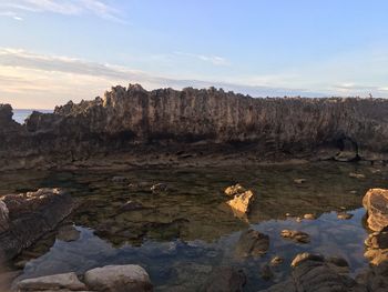 Rock formations on landscape against sky