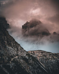 Smoke emitting from mountain against sky