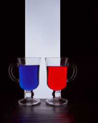 Close-up of beer glass on table against black background