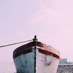 Low angle view of rusty ship on sea against sky