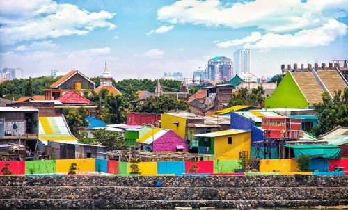 Multi colored cityscape against sky