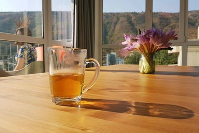 Close-up of flower vase on window sill at home