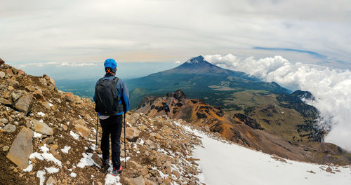 Rear view of man standing on mountain